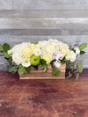 Shanah Tovah Blooms Rosh Hashanah flower arrangement with white hydrangea, roses, orchids, lisianthus, greenery and green apple in wooden box