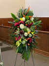 Tropical funeral standing spray with Birds of Paradise, roses, and exotic greenery on easel